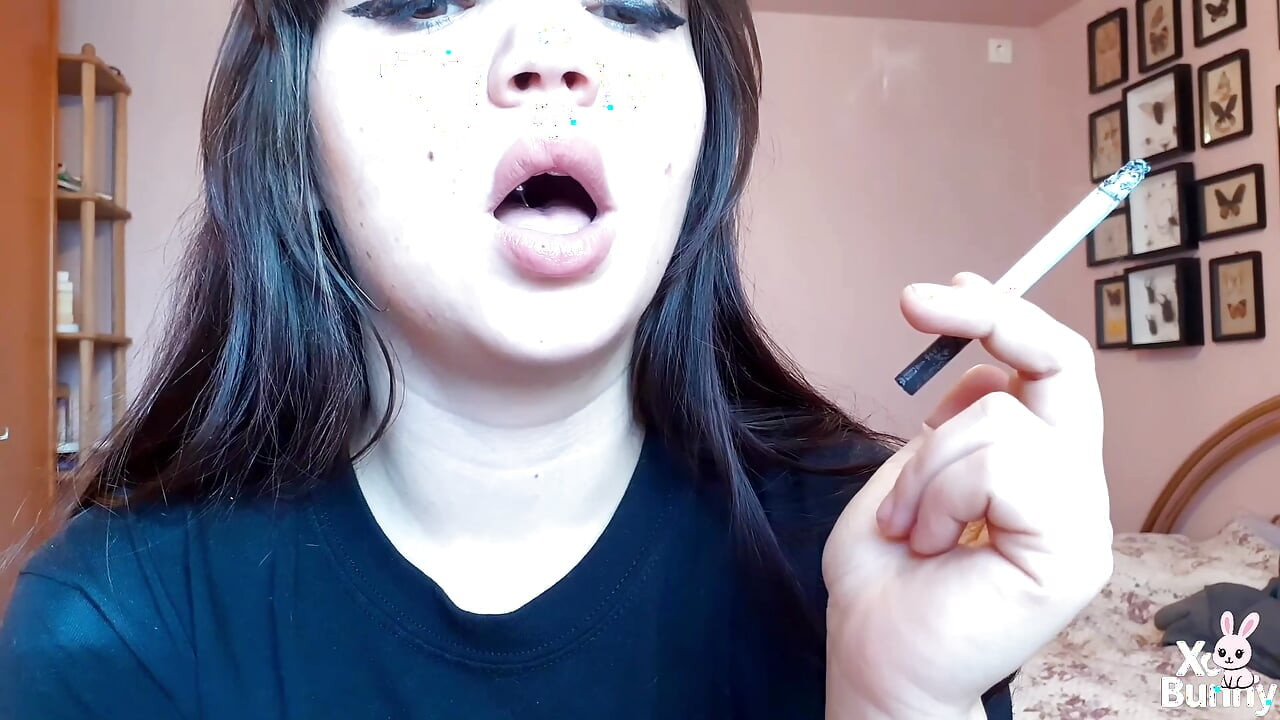 Big luscious lips with natural color lipgloss smoking cigarette