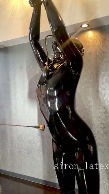 Lift the collar of the suspended latex doll and even more toys make her feel good
