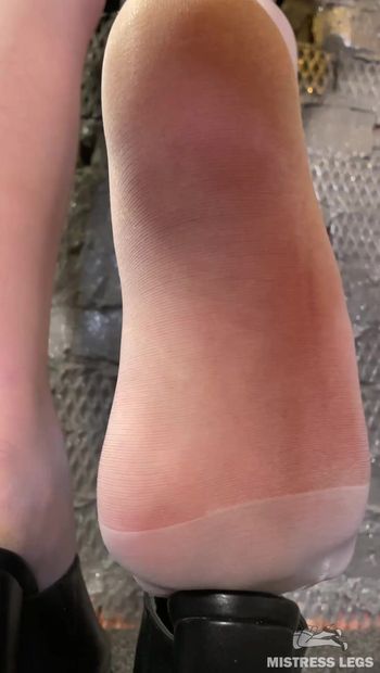 A Goddess in delicate white tights plays with her nylon feet with a clogs, rubs against it with her nylon toes, and wiggling her soles. A charming angle from the floor at the Mistress’s nylon feet.
