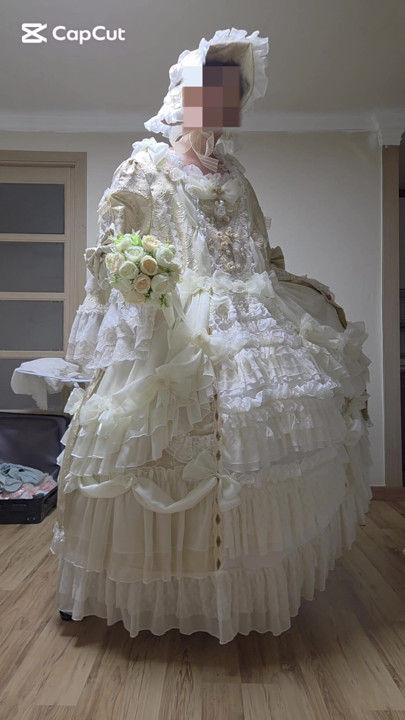 A man dressed as a woman dances in a dress.