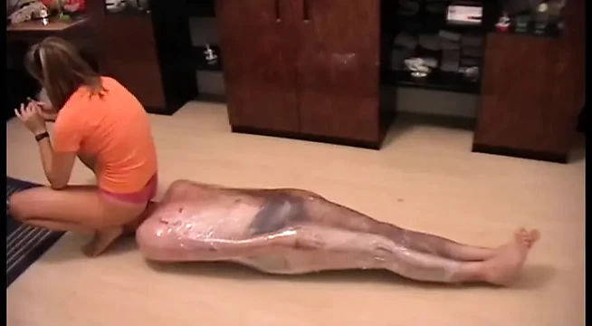 Nasty mistress tied up her slave with a plastic foil