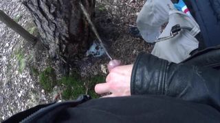 my boyfriend holding my pissing cock outdoor in the woods