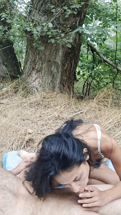 In the woods, on her knees, sucking the cock for her