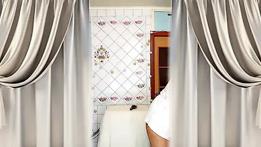 Real home solo of a mature woman in a small cozy kitchen.