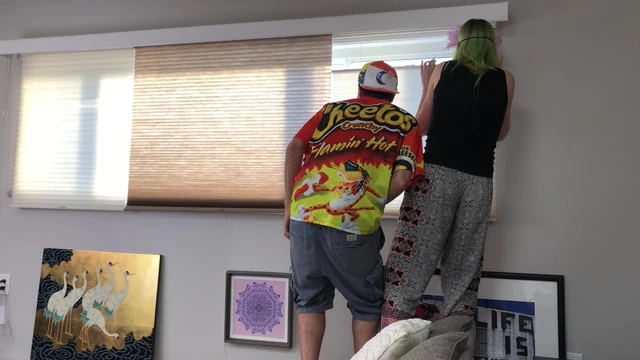 Couple Peeping Outside Apartment Window
