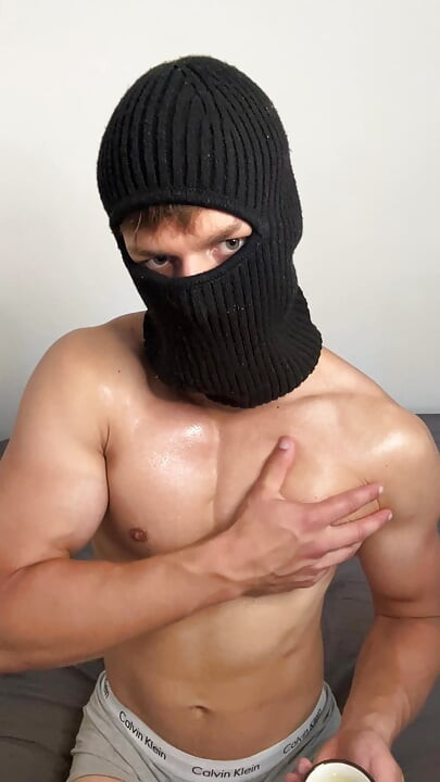 Masked horny hunk oiled up and teasing
