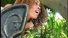Curly black dude fucks a cute olive skinned chick in the ass outdoors