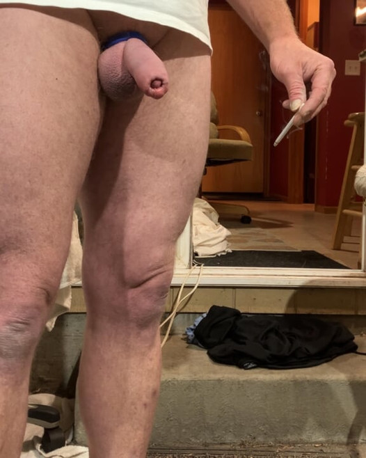 The Uncut Lounger pulling his pants and underwear down.