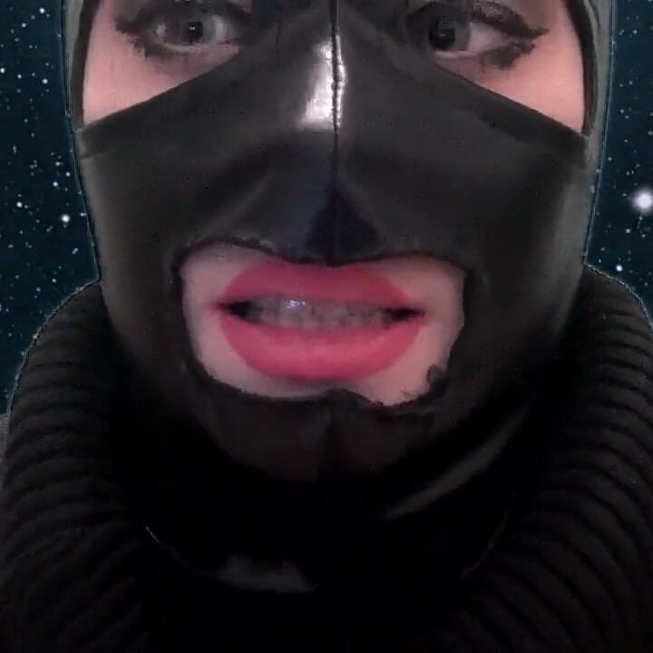 Smoking and teasing you in a latex mask