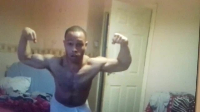 Black muscle flexing wearing a towel