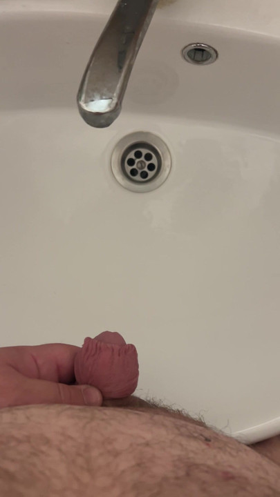 Fat man with a small dick pees in the sink