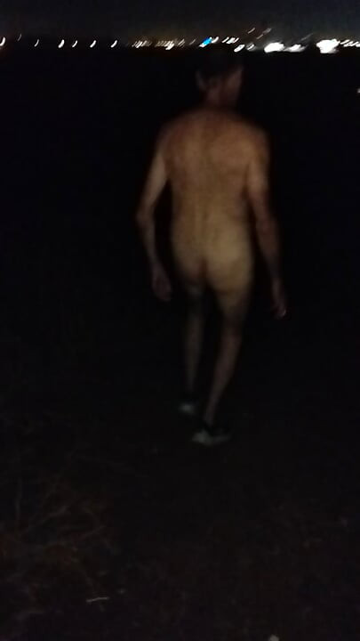 Naked walking on the hill along highway