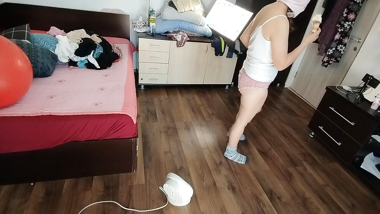 Amateur wife dancing naked at home. Amateur woman has fun trying on clothes and cutting them.