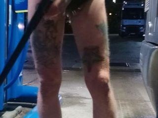 At the filling station with shorts and ripped ass