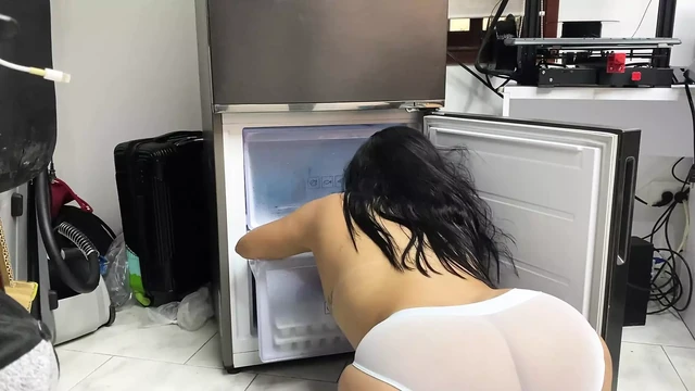 Filming the voluptuous maid cleaning the fridge
