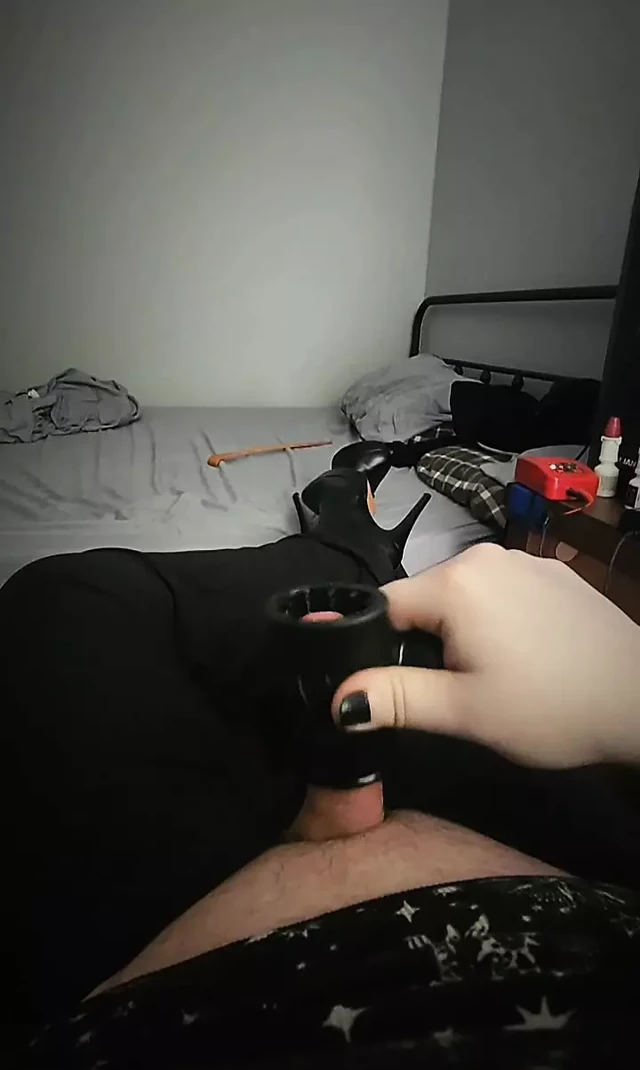 Goth trans girl in heels stroking her cock until she cums.