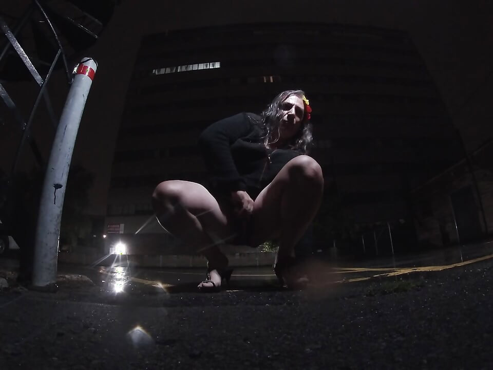 Mature sissy CD out in the rain in A parking lot in public masturbation.