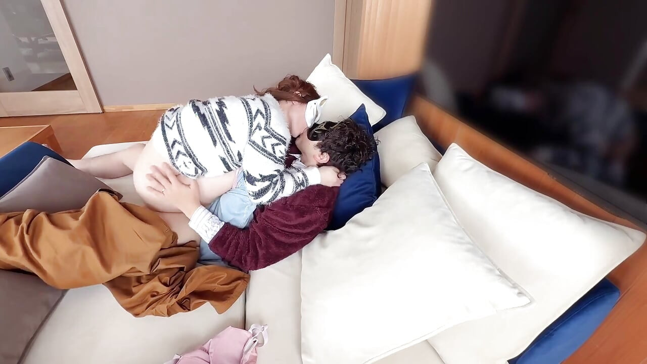 On the Sofa in Their Secret Room, They Shared Passionate Kisses Before Making Love, Expressing Their Deep Love.