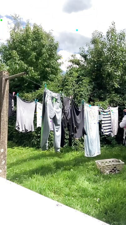 In gardening outfit to hang the laundry