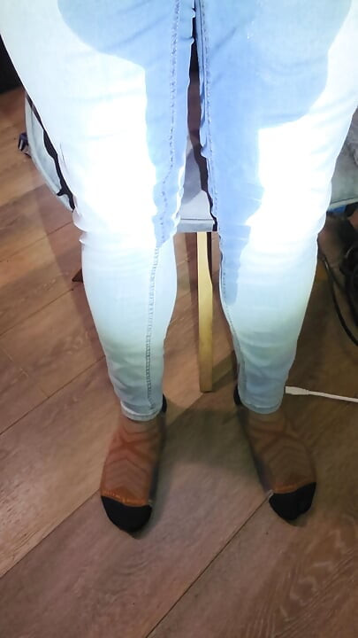 Desperately trying to hold but letting it all out in female light wash jeans