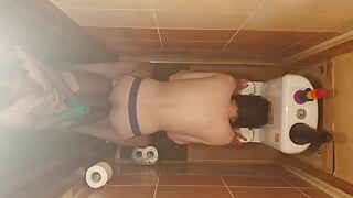 Anastasia Mistress punishes man with a long dildo in the ass in the toilet