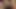 A beautiful young woman with captivating features offers her mouth to an enormous penis, providing it with a deep and satisfying blowjob.