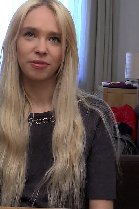 Blonde Babe Grips Purple Vibrator with Naughty Smile