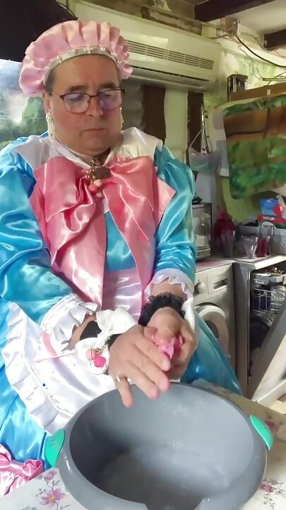 In a blue maid's outfit with pink bows to do the laundry.