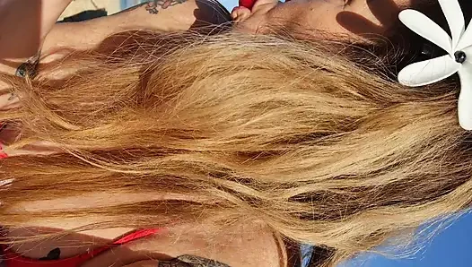Melissa Johnson sucks and licks a cherry lollipop on the .beach