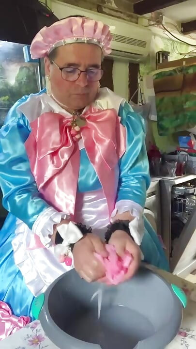In a blue maid's outfit with pink bows to do the laundry.