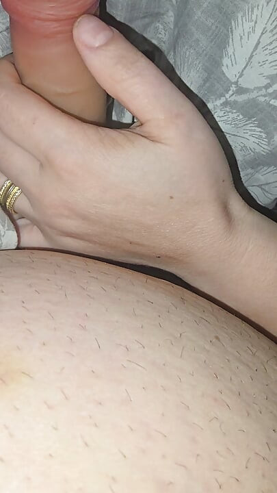 Step sister surprises step brother with a handjob while they watch a movie