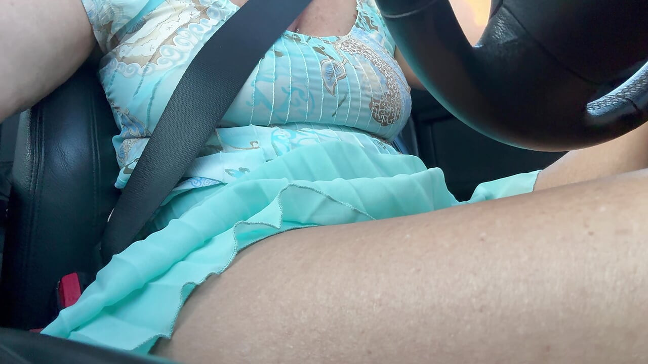 An elegant lady drives to work and rubs her pussy with her hand between her hot thighs