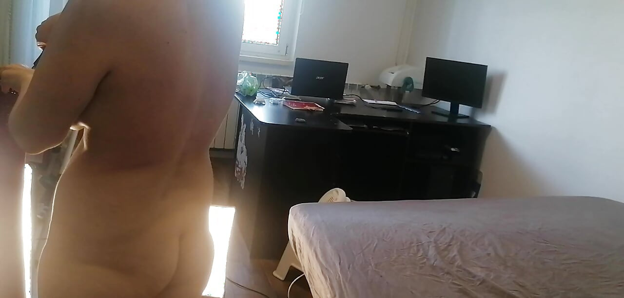 Amateur woman has fun trying on clothes and cutting them. Amateur woman vacuuming naked in the house.