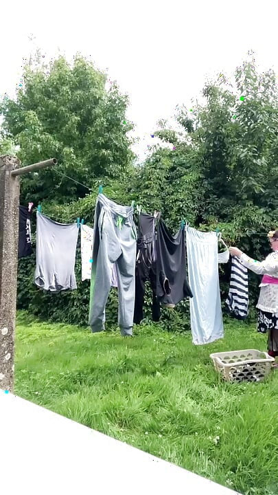 In gardening outfit to hang the laundry