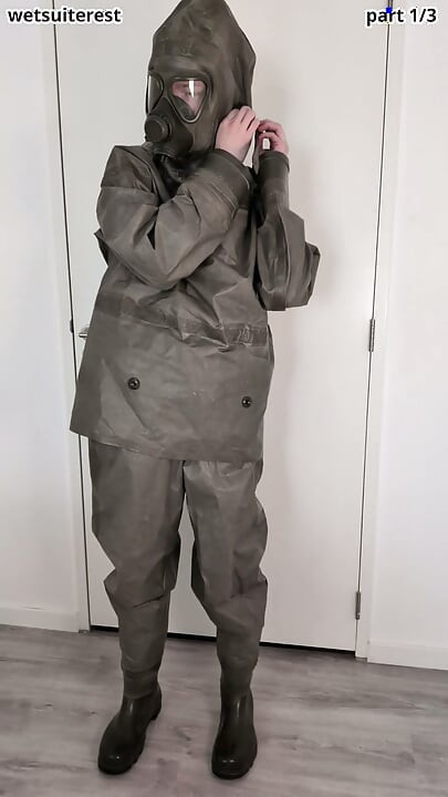 Putting on Zodiac Zodiak heavy rubber hazmat suit over plastic pants and gas mask