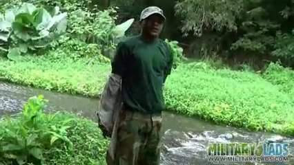 Brown soldier strips naked by the stream