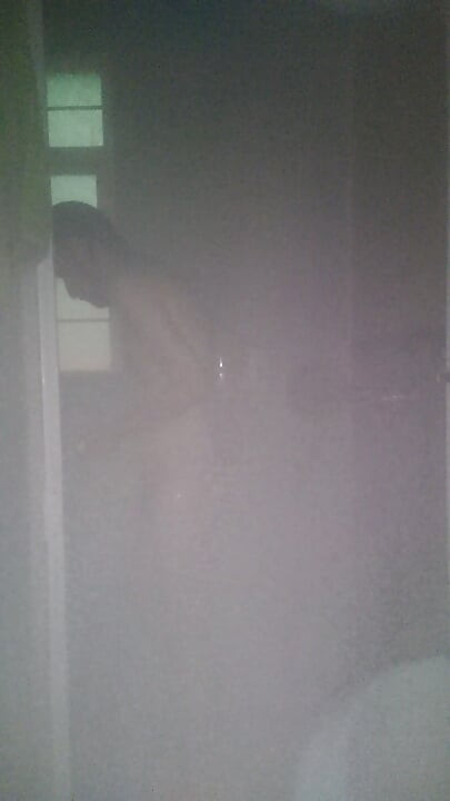Man Showering with Flashlight On