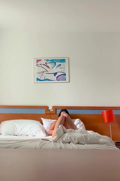 Woman Being Recorded in Hotel Room