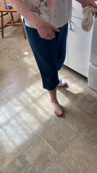 Mother in Law takes off shoe and sock to show me her foot