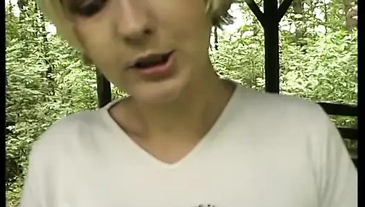 Short hair blonde bitch is fingering her wet pussy outdoors