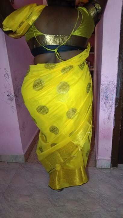 A Tamil wife in a saree swaying her back