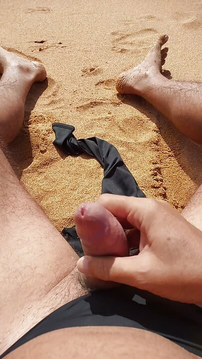 Ladysilva jerking off his big hot cock until he grasps on the deserted beach