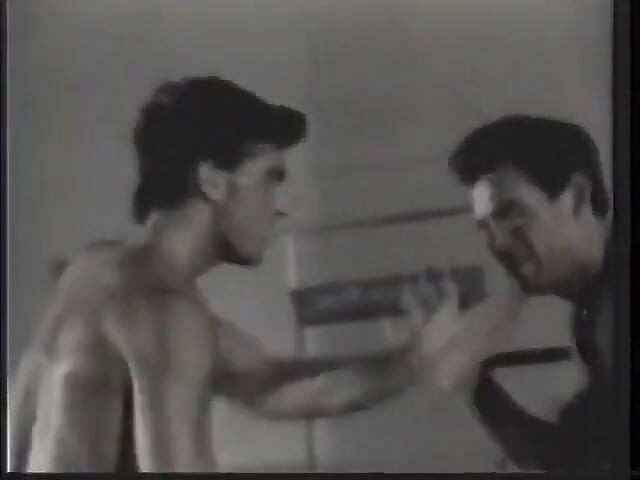 Two guys with ripped bodies are having a fight in the rink