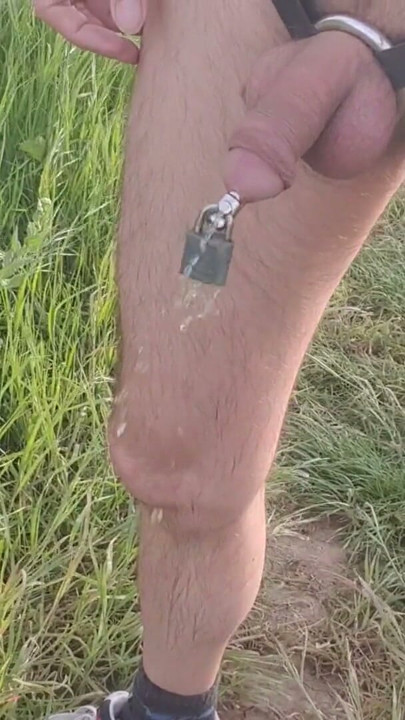 Outdoor walking and pissing locked in chastity device with urethral plug | Clip 1
