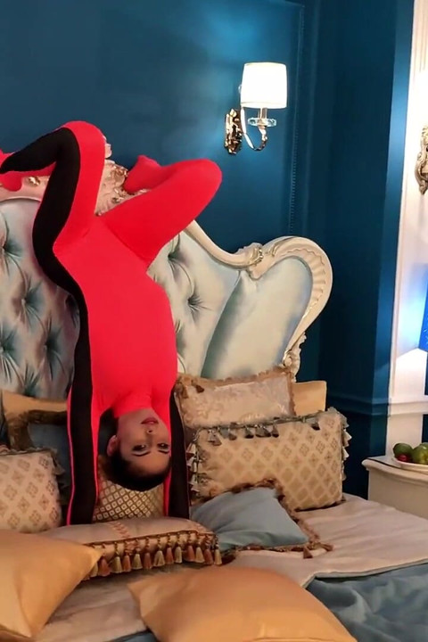 Stretching Flexibily on Hotel Bed