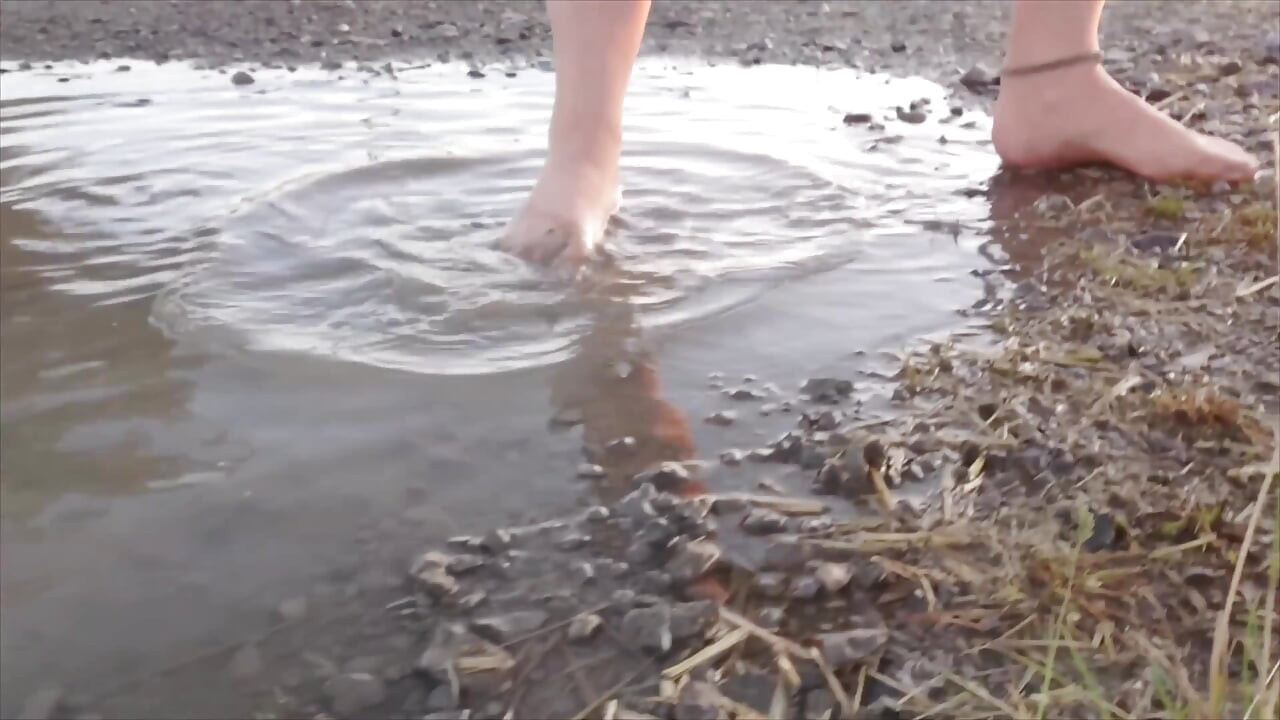 Bright Pantyhose and Beach Shoes in Puddle