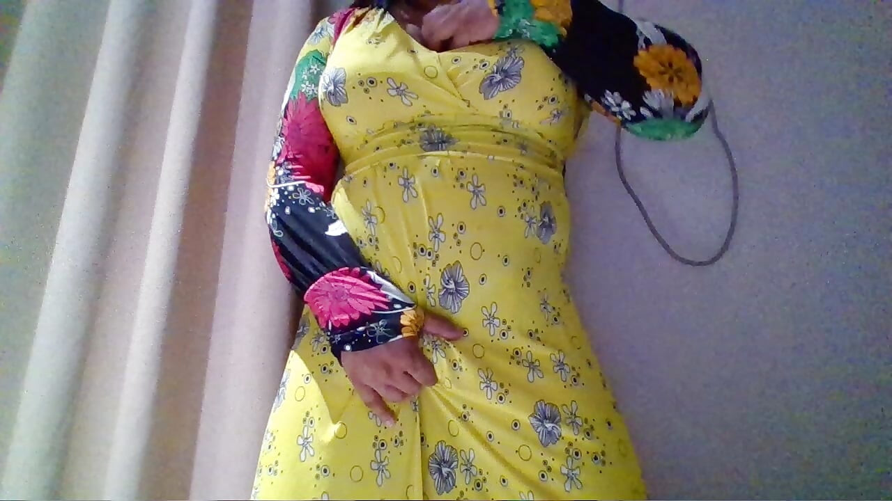 Crossdresser in a Yellow Maxi Gown