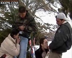 Two crazy girls give head kneeling in the snow on a ski desc