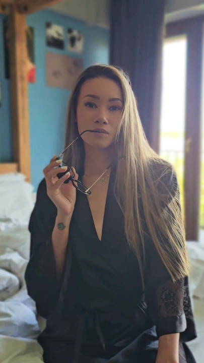 Hot asian woman with glasses in silk robe