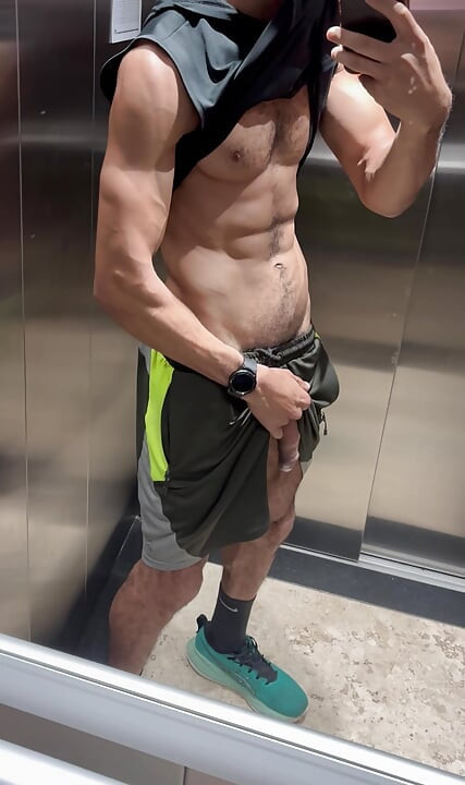 Hairy fitness guy showing off his thick cock in the elevator without underwear